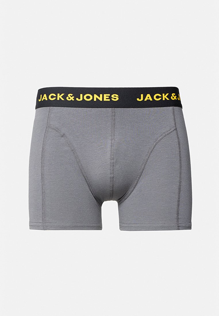 Boxers gris para hombre con cinturilla elástica negra que presenta el logo amarillo "JACK & JONES", detalles de costura visibles en la tela.