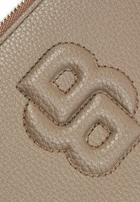 Beige textured leather pouch with embossed decorative elements and contrasting stitching along the edges, featuring a zip closure.