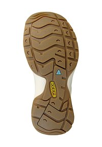 Rubber shoe sole with a textured beige surface, featuring a wave pattern and a KEEN logo. Designed for grip and durability.