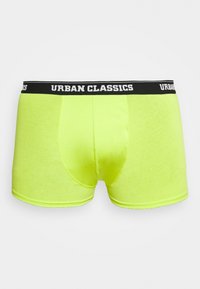 Neonski žuti bokserice s prilagođenim dizajnom, mekanom teksturom i crnim elastičnim pojasom koji prikazuje "URBAN CLASSICS" u bijelom.