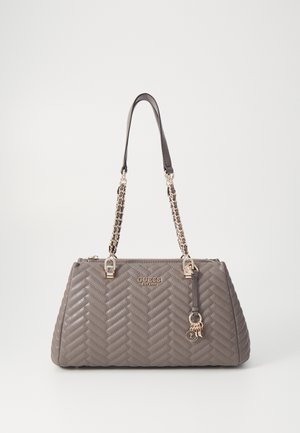 Gray quilted leather Guess handbag with gold chain straps, zipper closure, and decorative hanging charms on a white background.