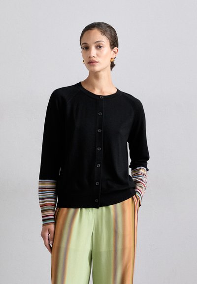 Black cardigan with button front and ribbed cuffs featuring multicolored stripes. Sweater has a smooth texture and relaxed fit.