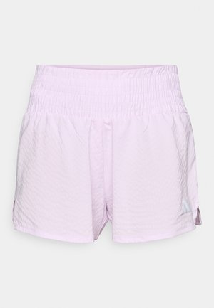 Calções atléticos rosa-claro com superfície texturizada, cintura elástica e fendas laterais. Apresenta um pequeno logotipo no lado inferior esquerdo.