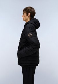 Black puffer jacket with a hood, featuring horizontal quilted sections and a round logo patch on the left sleeve. Smooth texture.