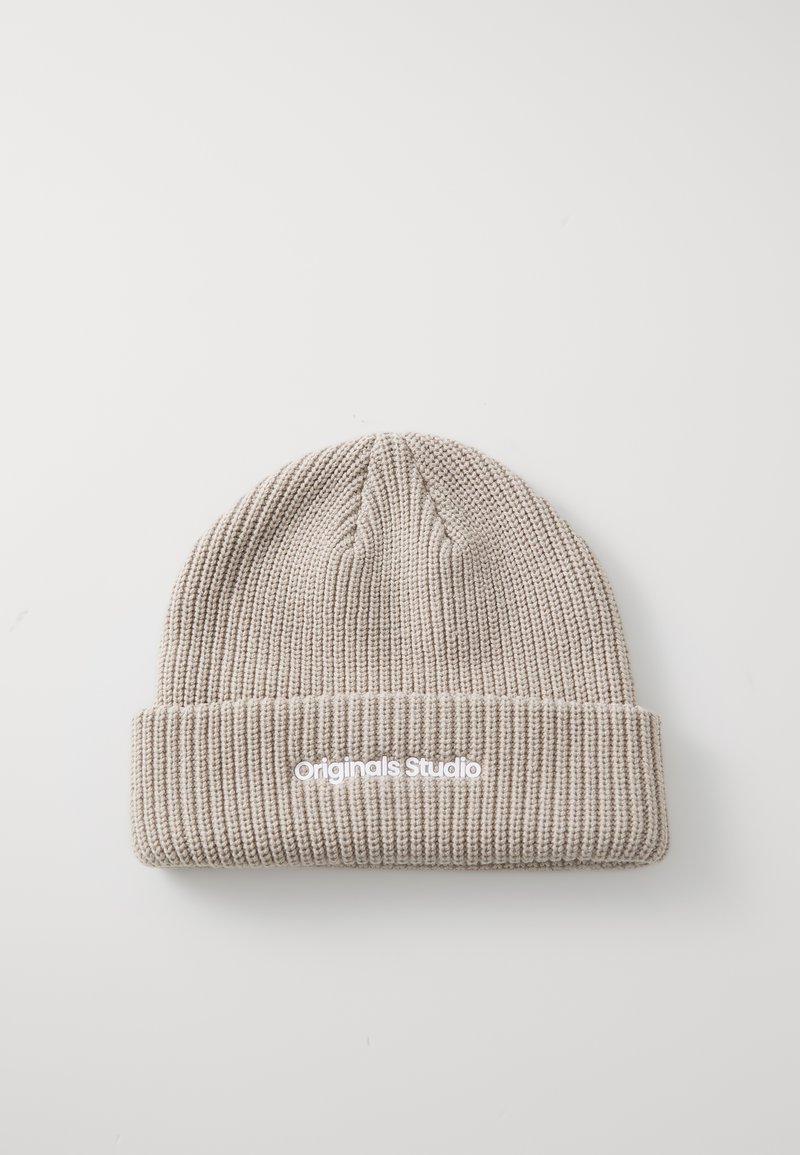 Brede gebreide beanie in lichtbeige met ribbelstructuur. Heeft een opgevouwen zoom en een geborduurd "Originals Studio" logo in het wit.