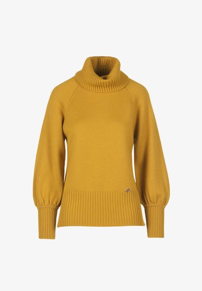 Mustard yellow knitted sweater with a high ribbed collar, raglan sleeves, and ribbed hem. Features a small metallic logo accent.