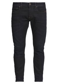 Tmavě modré úzké džíny s pěti kapsami, zapínáním na knoflíky a jemným vyblednutím na stehnech a kolenou.