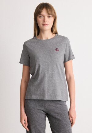 T-shirt grigio in cotone con maniche corte e scollo rotondo, con un piccolo logo "G" bordeaux sul lato sinistro del petto. Tessuto morbido.