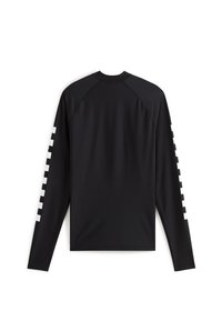Chemise noire à manches longues en tissu lisse, avec des carrés blancs en accent le long de la manche droite et un col rond classique.