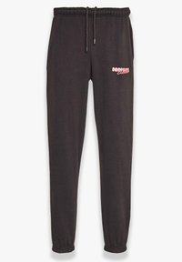 Schwarze Jogginghosen aus Baumwolle mit einem Kordelzugbund. Enthält ein pinkes Logo am linken Oberschenkel und schmal zulaufende Bündchen an den Knöcheln.