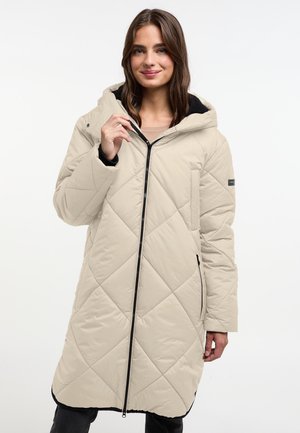 Beige, lange gewatteerde jas met een capuchon, voorzien van een ruitpatroon, een voorrits en zijzakken. Zwarte accenten aan de zoom.