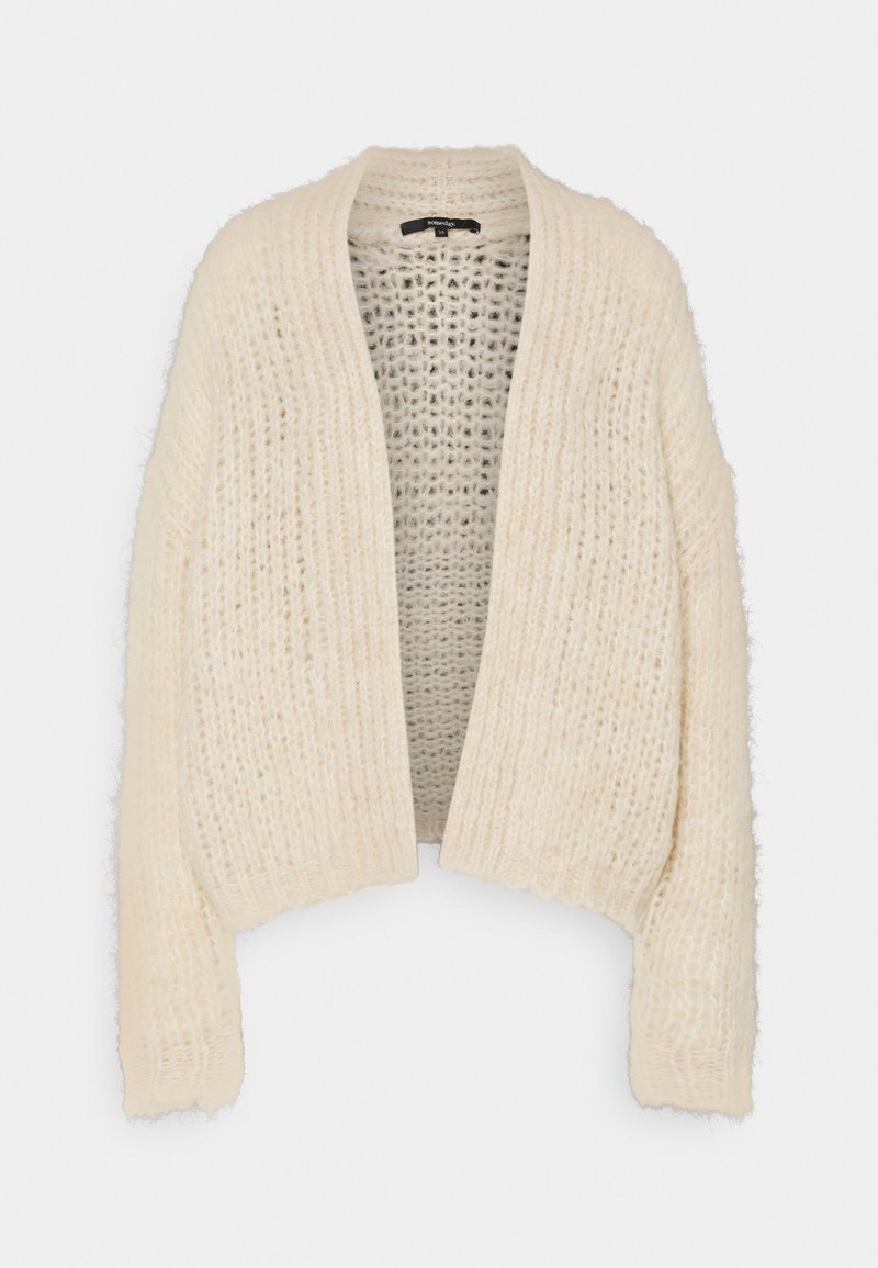 Krämfärgad stickad cardigan med öppen framsida, med en kraftig, texturerad väv och något kortade ärmar. Ingen knäppning.