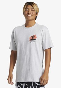 Light gray cotton t-shirt featuring a black and coral graphic design on the left chest. Crew neck and short sleeves, relaxed fit.