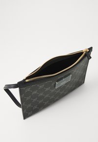 Black clutch bag with a gold zipper, featuring a logo plaque and a patterned exterior. The interior is lined and open.