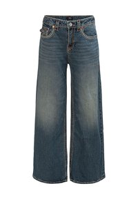 Dżinsy o szerokich nogawkach w średnim odcieniu niebieskiego z delikatnym efektiem wyblaknięcia. Posiadają pomarańczowe przeszycia, pięć kieszeni oraz zapięcie na guzik z przodu.