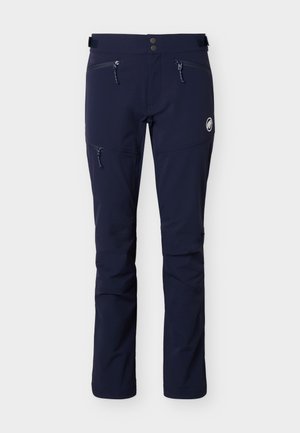 Marineblå udendørsbukser med to lynlåslommer foran, en lynlåslomme på låret, dobbeltradet knaplukning i taljen og et lille rundt logo på højre ben.