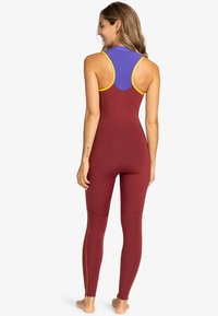 Full-body swimsuit featuring a maroon base with purple and yellow accents, a sporty design, and a smooth, stretchy fabric.