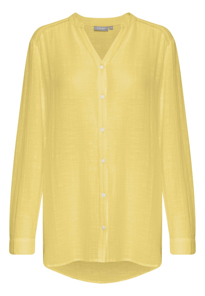 Blusa gialla chiara a maniche lunghe con bottoni, scollo a V e tessuto leggermente strutturato, con maniche a polsino e orlo leggermente curvo.
