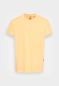 Yellow cotton t-shirt with a classic crew neck, short sleeves, and a small logo detail near the neckline. Smooth texture and straight cut.
