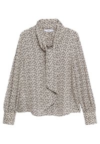 Blouse beige à manches longues avec un motif de tirets noirs dispersés et un détail de foulard noué au col, dotée de larges poignets et d'une coupe ample.