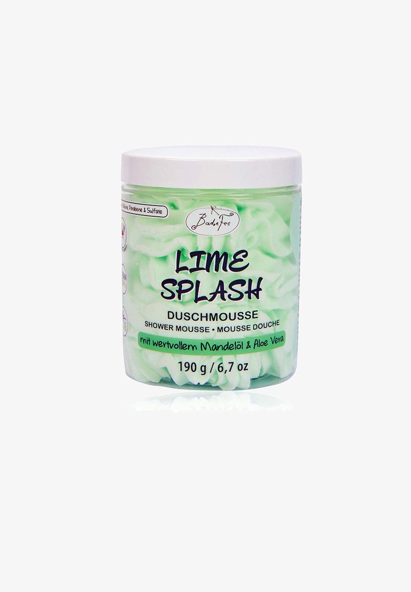 Green plastic container of "Lime Splash" shower mousse, features a white lid, wavy mousse texture visible inside, text in black and green.