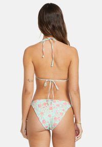 Bikini set features a light blue floral pattern with pink accents, adjustable tie straps, and a classic cut for bottom and top.