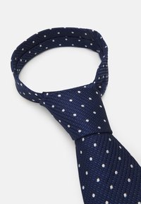 Marineblauer Krawatte mit weißen Punkten, aus strukturiertem Stoff gefertigt. Verfügt über ein klassisches Schlaufen-Design und eine glatte Oberfläche.