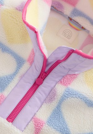 Fleece jacket with pastel heart patterns in pink, yellow, and blue, featuring a pink zipper and colorful interior label.