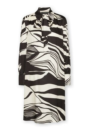 Vestito con motivo a fantasia bianco e nero, con colletto, maniche lunghe e dettaglio a fiocco sullo scollo. Realizzato in tessuto liscio e leggero.