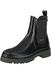 Schwarze Leder Chelsea-Boots mit elastischen Seitenteilen und einer abgerundeten Spitze. Mit einer strukturierten, massiven schwarzen Laufsohle und einem kleinen goldenen Logo.