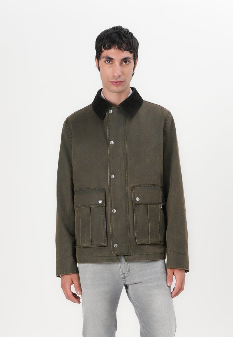 Olive green jacket with a corduroy collar, snap buttons, and two front pockets; made from sturdy fabric with visible stitching details.