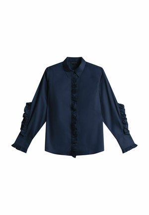 Marinblå skjorta med långa ärmar och volangdetaljer, krage och en central panel med volanger framtill. Slät textur. Klassisk passform.