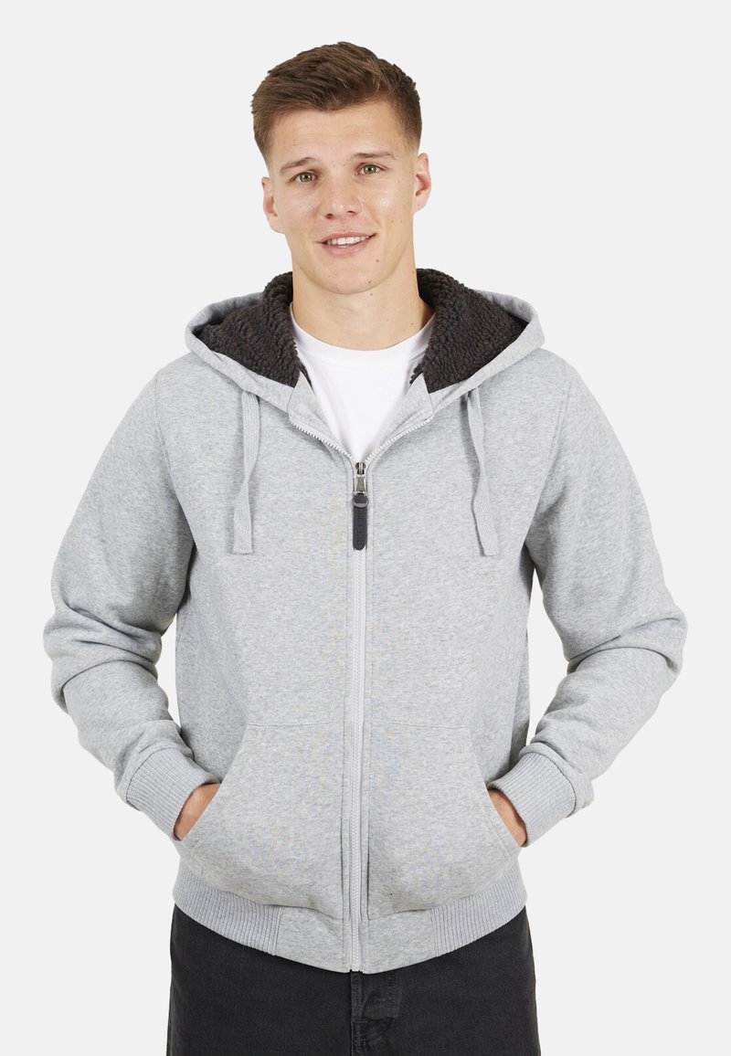 Grijze zip-up hoodie met een gestructureerde, donkergrijze fleece-voering in de capuchon, voorzakken en ribgebreide boorden. Eenvoudig ontwerp, casual pasvorm.