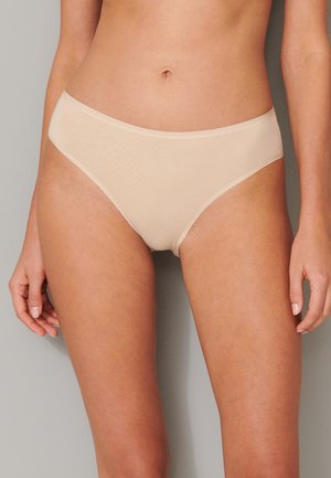 Beige seamless brief with a smooth texture and regular rise, featuring a simple elastic waistband and minimalistic design.