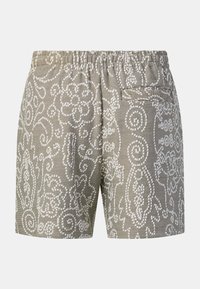 Shorts beige et blanc texturés avec une taille élastique et une seule poche fendue à l’arrière, ornés d’un motif floral abstrait.