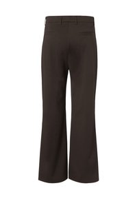 Pantalon noir sur mesure avec une jambe légèrement évasée, passants de ceinture et deux poches passepoilées à l’arrière.