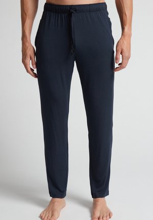Navy loungebroeken van zacht materiaal, met een elastische tailleband en trekkoord, recht gesneden en met aangesloten boorden.
