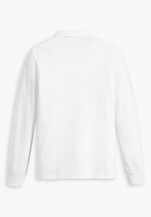 Långärmad polotröja i solid vit bomull med klassisk krage, rak nederkant och manschetter med knapplås. Minimalistisk design.