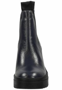 Bota de tobillo de cuero azul marino con un acabado brillante, puño elástico y suela de goma negra gruesa. El diseño presenta costuras aerodinámicas.