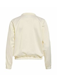 Veste bomber crème à manches longues avec poignets et taille élastiques, présentée vue de dos sur fond blanc.