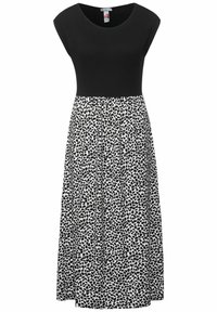 Musta vartaloasu, jossa on lyhyet hihat ja virtaava, polvimittainen hame, jossa on valko-mustaa lehtikuviota. Joustava vyötärö mukavuutta varten.