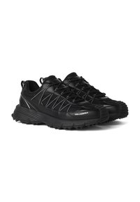 Ζευγάρι μαύρα chunky sneakers με ανάγλυφες λαστιχένιες σόλες, επάνω μέρος από δίχτυ και δέρμα, κλείσιμο με κορδόνια και λογότυπο "KARL LAGERFELD" στο πλευρό.