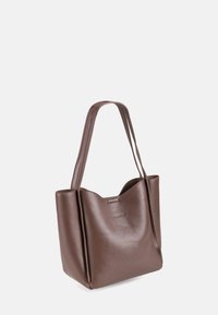 Braune Leder-Tasche mit glatter Textur, strukturierter Form und zwei Schulterriemen. Verfügt über ein dezentes Logo und abgerundete obere Kanten.