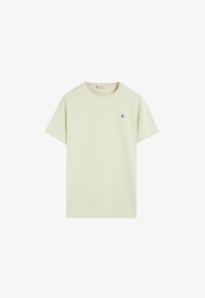 Simpel lysebeige T-shirt med kortærmer, rund hals og lille mørkt kranium og korslagte knogler logo på venstre bryst.