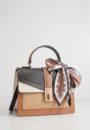 Structured handbag with black, white, tan, and beige panels, gold clasp, top handle, and a tied patterned silk scarf on the handle.