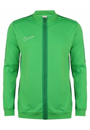 Grüne Nike-Trainingsjacke mit durchgehendem Reißverschluss, Stehkragen, seitlichen Taschen und weißem Logo auf der linken Brust. Glatter Stoff.
