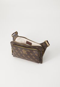 Pruun mustriga käekott kuldse riistvaraga, kahe tõmblukuga ja reguleeritava rihmaga. Siseosa on beeži voodriga ja logotagiga.