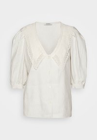 Krämfärgad knapp-up blus med djup V-ringning, stickad krage, vertikala ränder och puffärmar med elastiska ärmslut.