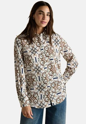 Langärmliges Hemd mit Knopfleiste aus weißem Stoff, das ein geometrisches Muster in Braun, Grün und Blau aufweist. Klassischer Kragen und abgerundeter Saum.