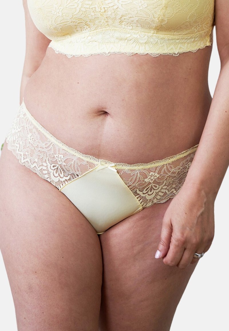 Yellow lace bralette and matching panties, featuring floral patterns, soft satin accents, and an elastic waistband with intricate lace trim.